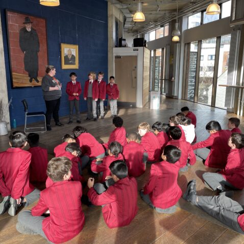 Year 5 school pupils sit in a group at the Rose Theatre in Kingston