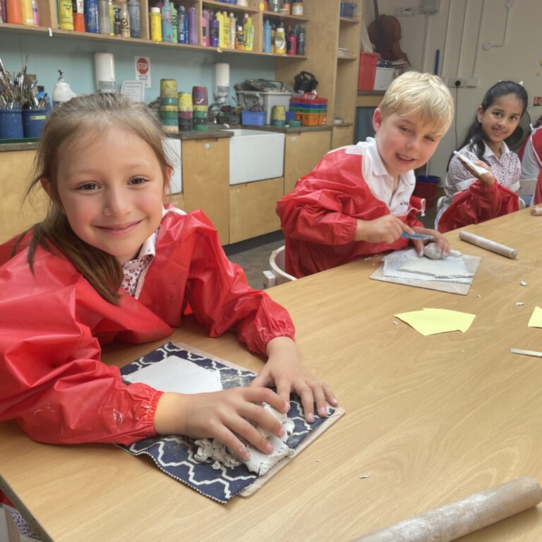 Children making tudor houses from clay