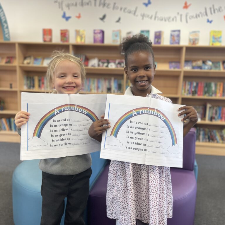 Two girls with poems about rainbows