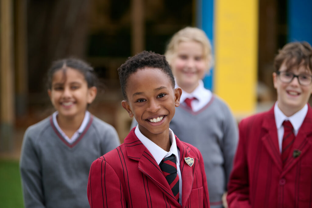 A mixed group of school pupils in the playground at The Mall School