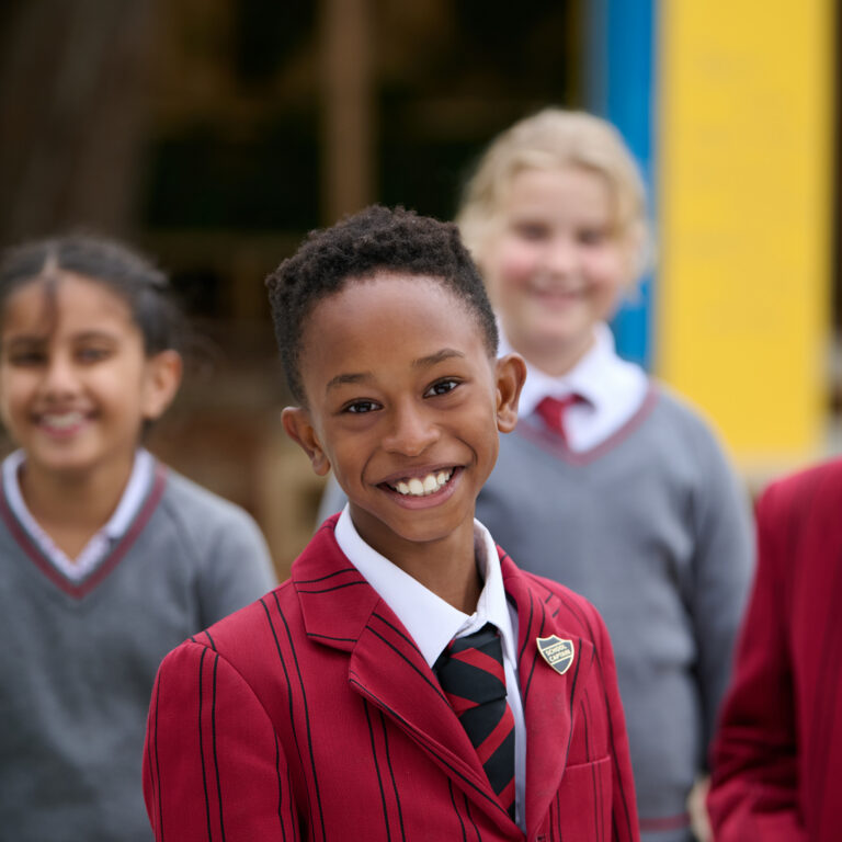 A mixed group of school pupils in the playground at The Mall School