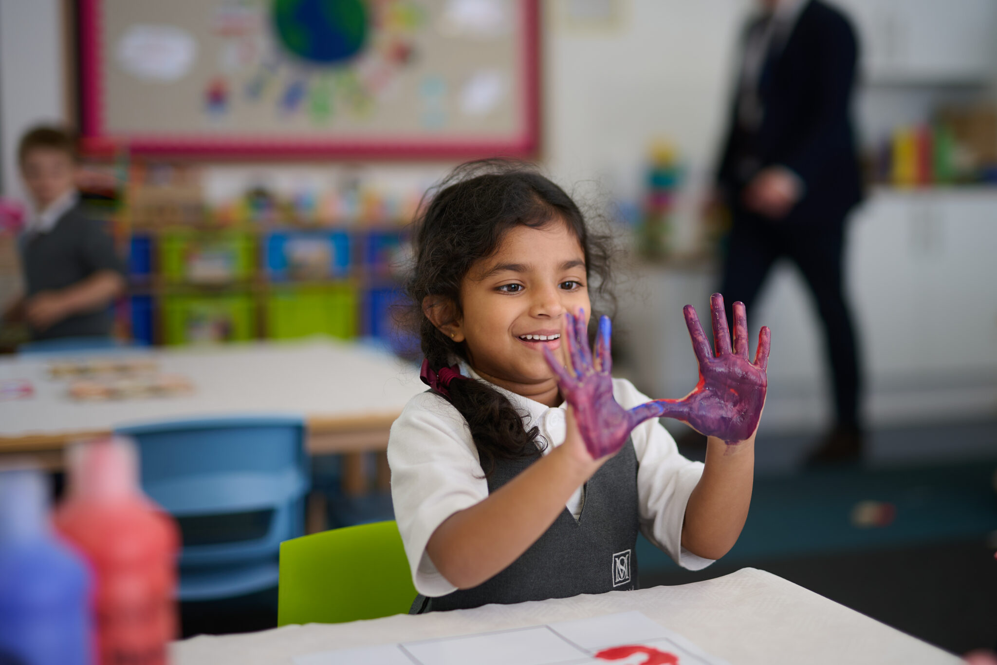 Mixing two primary paint colours to make a third new colour at The Mall School