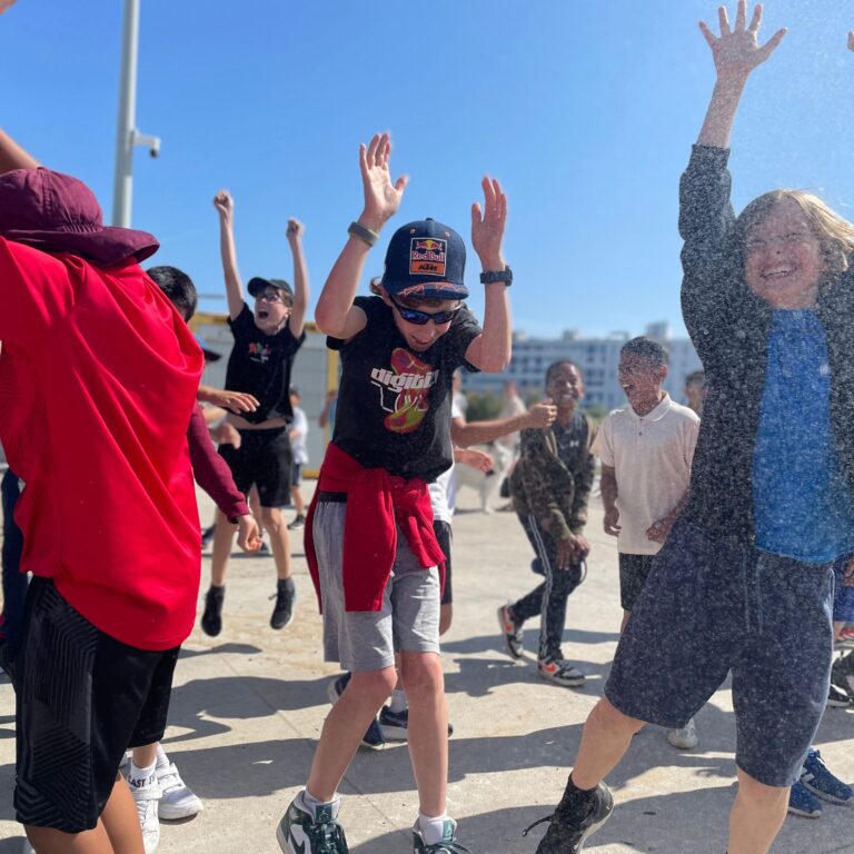 Delighted children in the French sunshine, getting splashed with water
